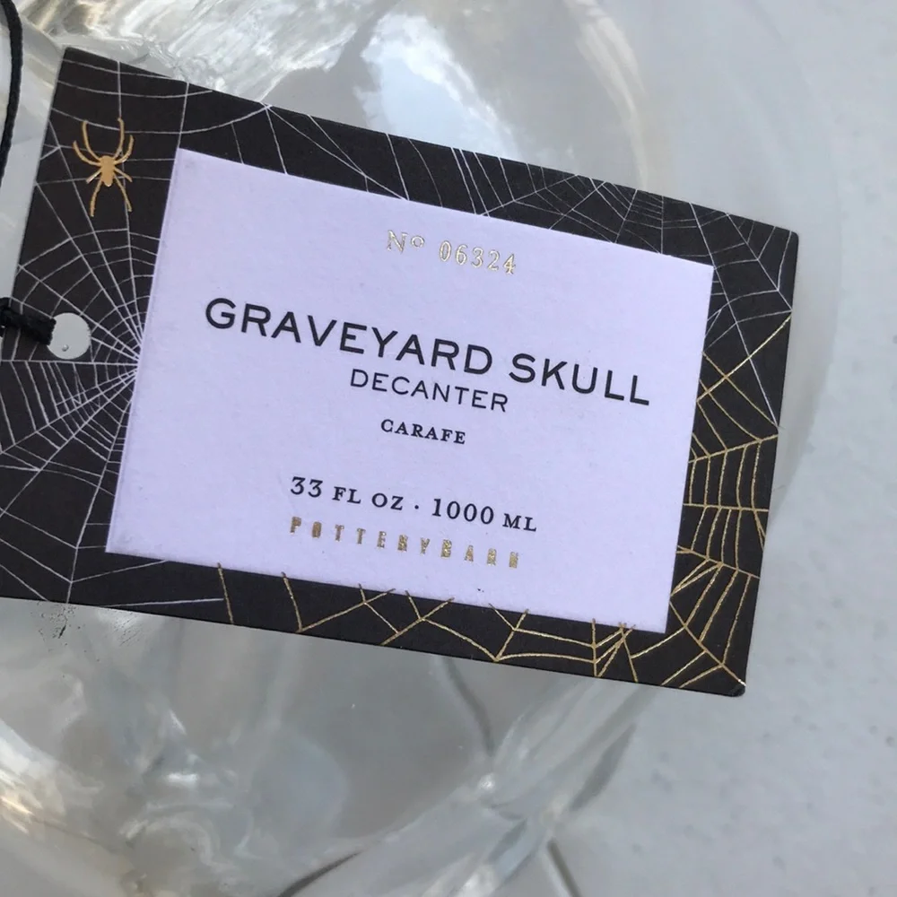 Pottery Barn graveyard skull decanter BN